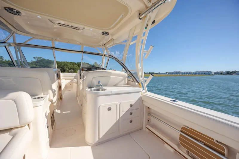  Yacht Photos Pics 2020 Grady-White Freedom 307 boat interior with seating and water view.