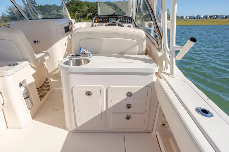  Yacht Photos Pics 2020 Grady-White Freedom 307 boat interior with sink and storage, on calm water.