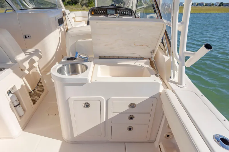  Yacht Photos Pics 2020 Grady-White Freedom 307 boat interior with sink, storage, and open compartment by the water.