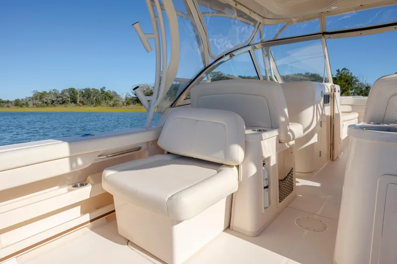  Yacht Photos Pics 2020 Grady-White Freedom 307 boat interior with comfortable seating and scenic water view.