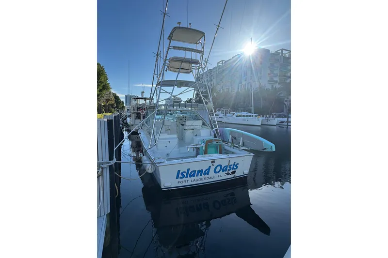 Island Oasis Yacht Photos Pics 2001 Cabo 35 Express boat docked, named "Island Oasis," in Fort Lauderdale marina.