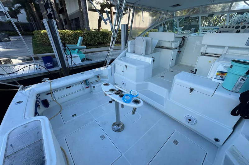 Island Oasis Yacht Photos Pics 2001 Cabo 35 Express boat interior with fishing gear and seating area.