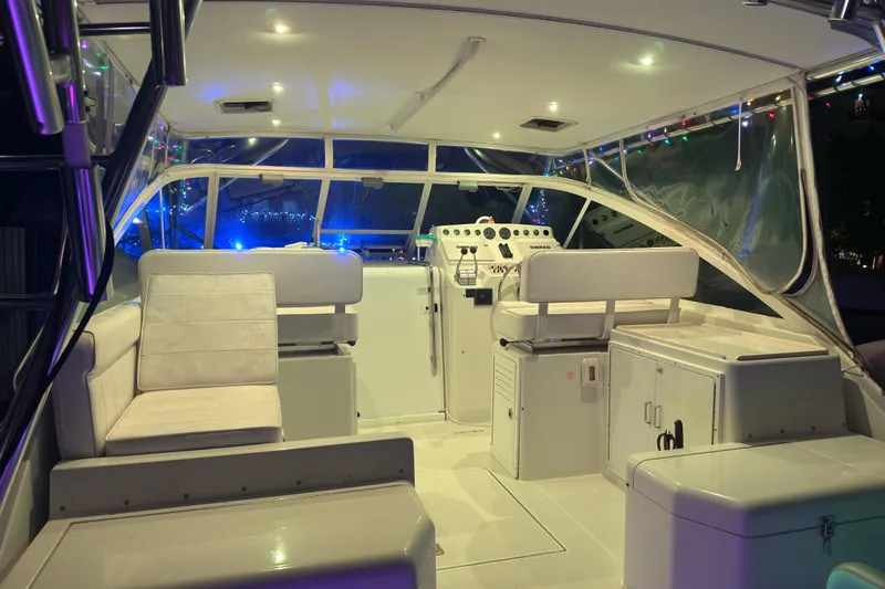 Island Oasis Yacht Photos Pics 2001 Cabo 35 Express boat interior with seating and control panel, illuminated at night.