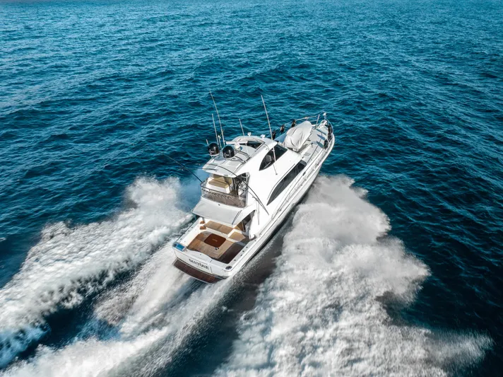 Riviera 61 Enclosed Flybridge Yacht Photos Pics 2011 Riviera 61 Enclosed Flybridge cruising on open ocean waters.