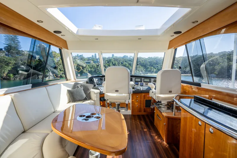 Riviera 61 Enclosed Flybridge Yacht Photos Pics Luxurious 2011 Riviera 61 Enclosed Flybridge interior with panoramic windows and elegant seating.