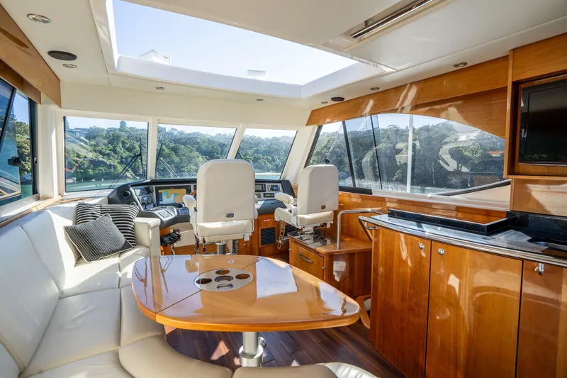 Riviera 61 Enclosed Flybridge Yacht Photos Pics Luxurious interior of 2011 Riviera 61 Enclosed Flybridge yacht with modern helm and seating.