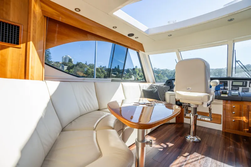 Riviera 61 Enclosed Flybridge Yacht Photos Pics Luxurious interior of 2011 Riviera 61 Enclosed Flybridge with leather seating and panoramic windows.