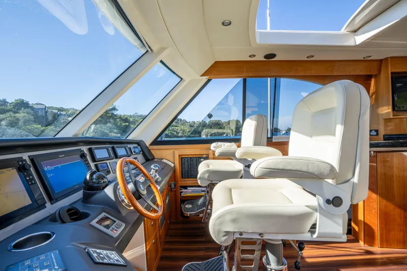 Riviera 61 Enclosed Flybridge Yacht Photos Pics Interior of 2011 Riviera 61 Enclosed Flybridge with modern helm and luxurious seating.