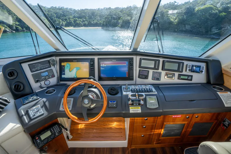 Riviera 61 Enclosed Flybridge Yacht Photos Pics Cockpit of 2011 Riviera 61 Enclosed Flybridge with advanced navigation systems and scenic water view.