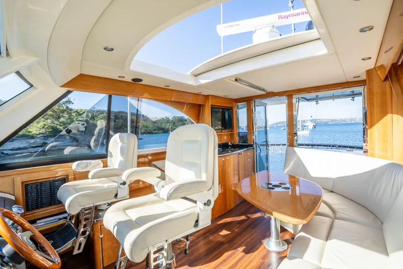 Riviera 61 Enclosed Flybridge Yacht Photos Pics Luxurious 2011 Riviera 61 Enclosed Flybridge interior with plush seating and panoramic ocean views.