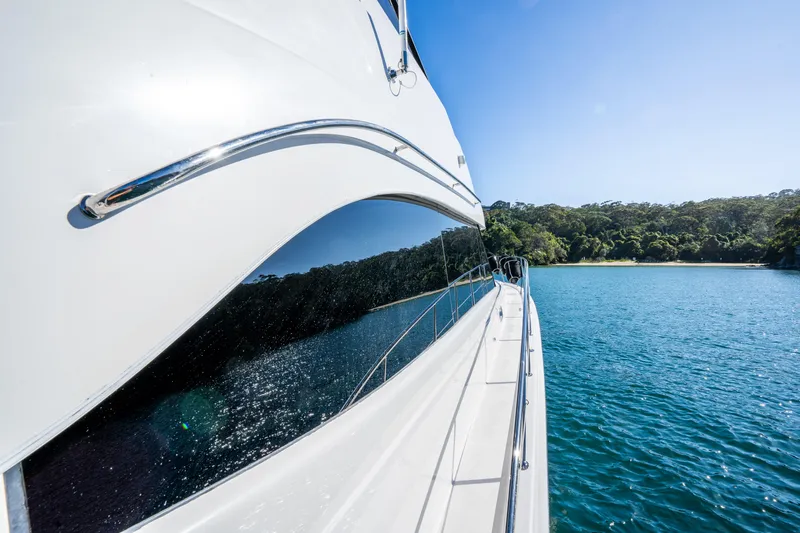 Riviera 61 Enclosed Flybridge Yacht Photos Pics Riviera 61 Enclosed Flybridge yacht cruising on clear blue water, 2011 model.