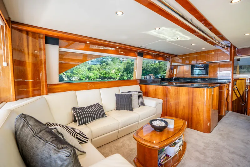 Riviera 61 Enclosed Flybridge Yacht Photos Pics Luxurious interior of 2011 Riviera 61 Enclosed Flybridge yacht with elegant wood finishes.