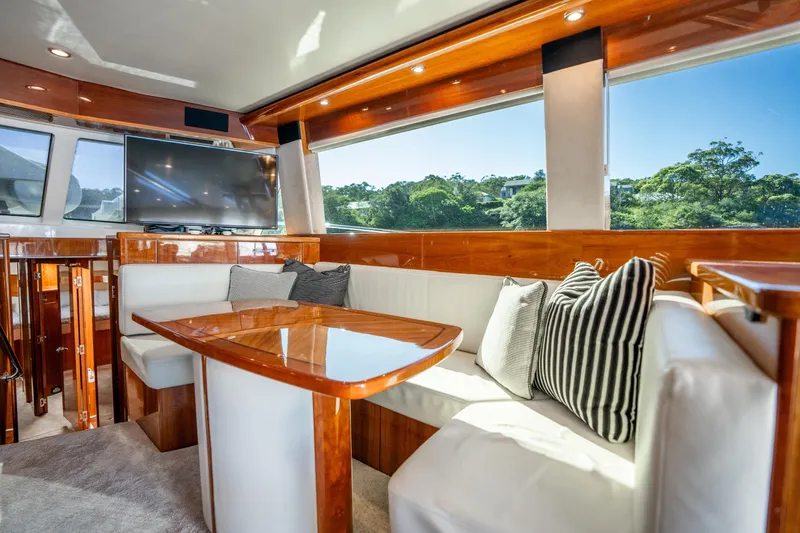 Riviera 61 Enclosed Flybridge Yacht Photos Pics Luxurious interior of 2011 Riviera 61 Enclosed Flybridge yacht with plush seating and large windows.