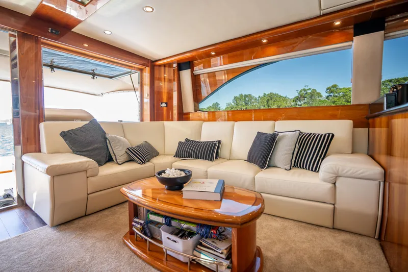 Riviera 61 Enclosed Flybridge Yacht Photos Pics Luxurious interior of 2011 Riviera 61 Enclosed Flybridge with plush seating and elegant decor.