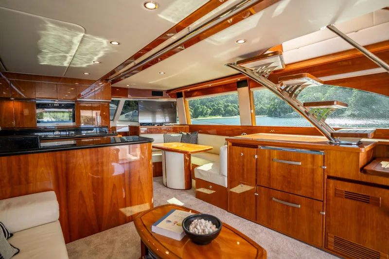 Riviera 61 Enclosed Flybridge Yacht Photos Pics Luxurious interior of 2011 Riviera 61 Enclosed Flybridge yacht with elegant wood finishes.