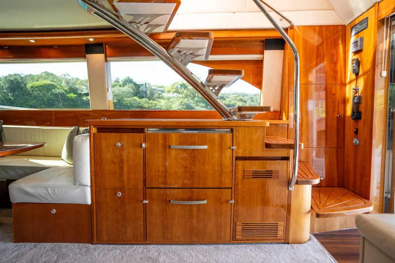 Riviera 61 Enclosed Flybridge Yacht Photos Pics Luxurious interior of 2011 Riviera 61 Enclosed Flybridge yacht with wooden cabinetry and seating.