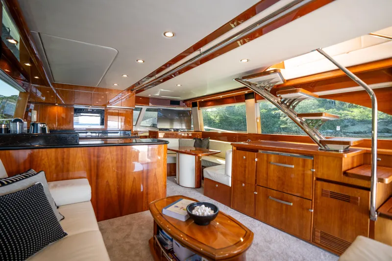 Riviera 61 Enclosed Flybridge Yacht Photos Pics Luxurious interior of 2011 Riviera 61 Enclosed Flybridge yacht with elegant wood finishes.