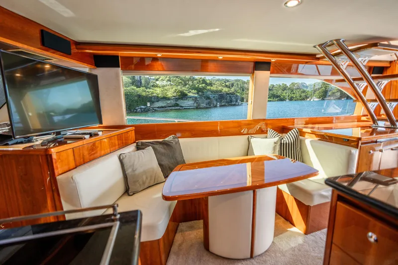 Riviera 61 Enclosed Flybridge Yacht Photos Pics Luxurious interior of 2011 Riviera 61 Enclosed Flybridge yacht with scenic water view.