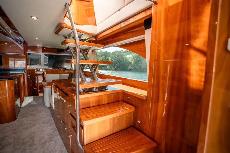 Riviera 61 Enclosed Flybridge Yacht Photos Pics Luxurious 2011 Riviera 61 Enclosed Flybridge interior with elegant wooden staircase and modern design.