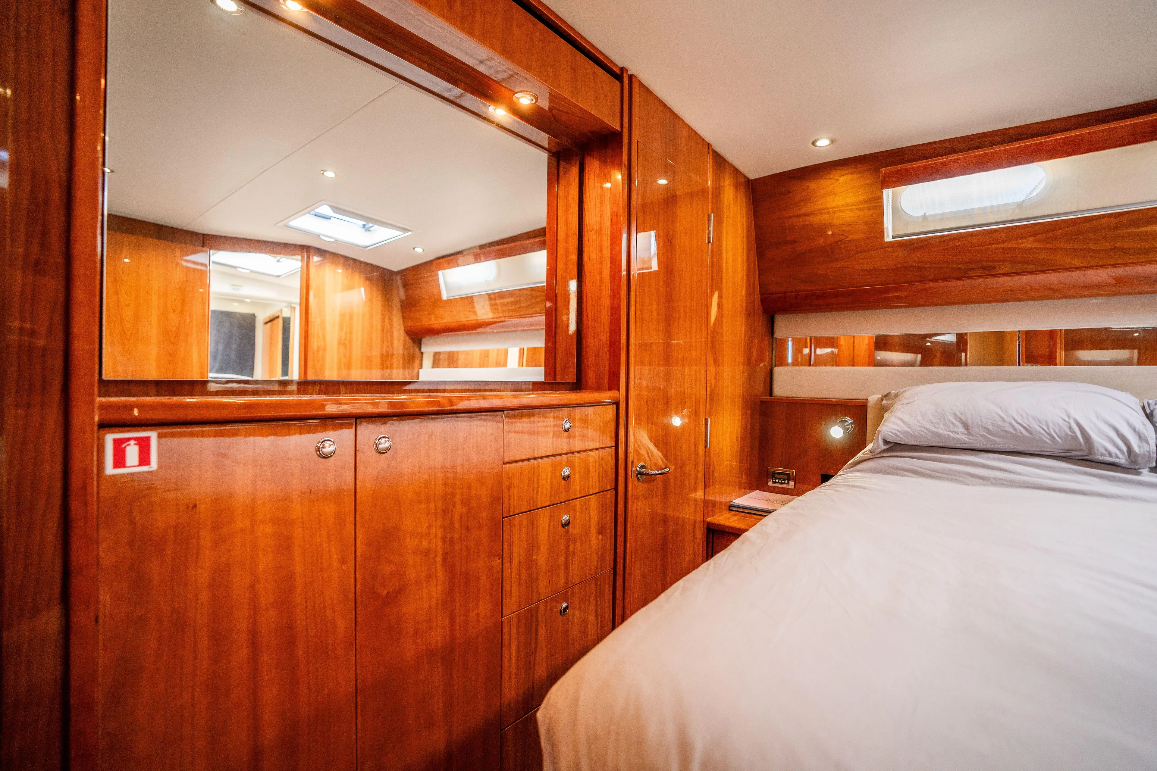 Riviera 61 Enclosed Flybridge Yacht Photos Pics Luxurious wood-paneled bedroom interior of 2011 Riviera 61 Enclosed Flybridge yacht.