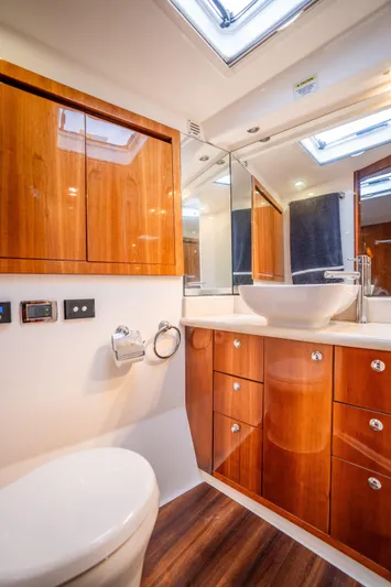 Riviera 61 Enclosed Flybridge Yacht Photos Pics Luxurious bathroom in 2011 Riviera 61 Enclosed Flybridge yacht with wood cabinetry and modern fixtures.