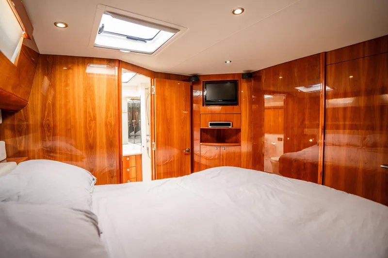 Riviera 61 Enclosed Flybridge Yacht Photos Pics Luxurious cabin interior of 2011 Riviera 61 Enclosed Flybridge yacht with wood paneling.