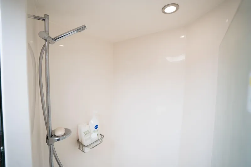 Riviera 61 Enclosed Flybridge Yacht Photos Pics Shower area in 2011 Riviera 61 Enclosed Flybridge yacht, featuring modern fixtures and lighting.