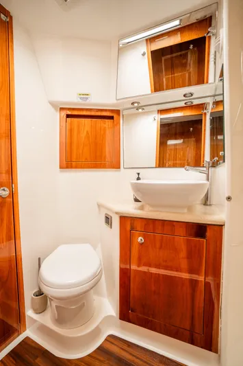 Riviera 61 Enclosed Flybridge Yacht Photos Pics Luxurious bathroom in 2011 Riviera 61 Enclosed Flybridge yacht with wooden cabinetry.