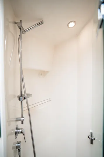 Riviera 61 Enclosed Flybridge Yacht Photos Pics Shower area in 2011 Riviera 61 Enclosed Flybridge yacht, featuring modern fixtures and lighting.