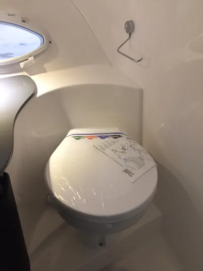  Yacht Photos Pics Compact bathroom in Hanover 305, 2025 model, featuring a modern toilet and sleek design.