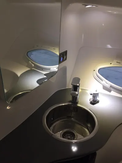  Yacht Photos Pics Modern Hanover 305 aircraft lavatory sink with mirror, 2025 model, featuring sleek design and lighting.