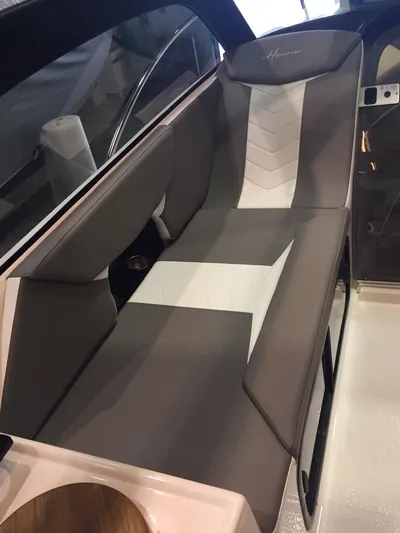  Yacht Photos Pics Luxurious seating in 2025 Hanover 305 boat, featuring sleek gray and white upholstery.