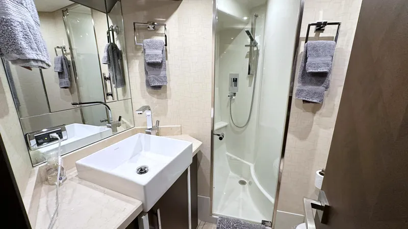  Yacht Photos Pics Luxurious bathroom in 2012 Marquis 720 Fly Bridge yacht with modern fixtures and elegant design.