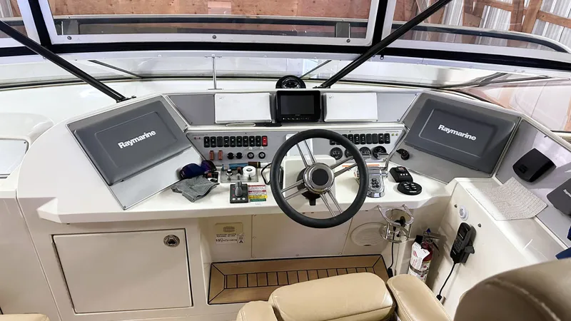  Yacht Photos Pics Helm of 2012 Marquis 720 Fly Bridge yacht with Raymarine navigation displays.