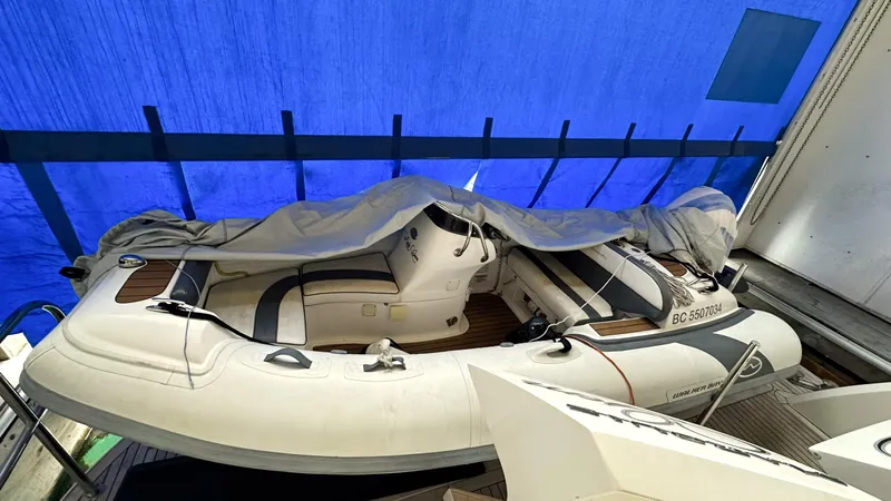  Yacht Photos Pics Inflatable boat under blue tarp on Marquis 720 Fly Bridge, 2012 model.