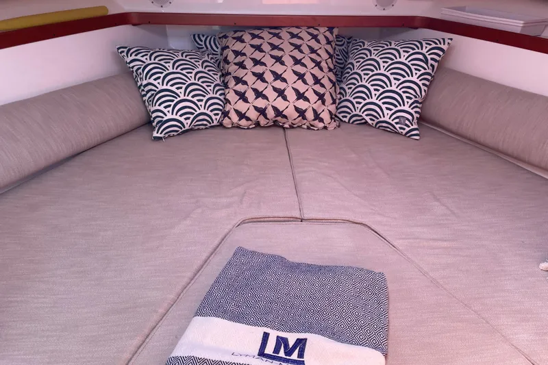 Tenacity Yacht Photos Pics Cozy cabin interior of 2012 Hunt Surfhunter with patterned pillows and blanket.