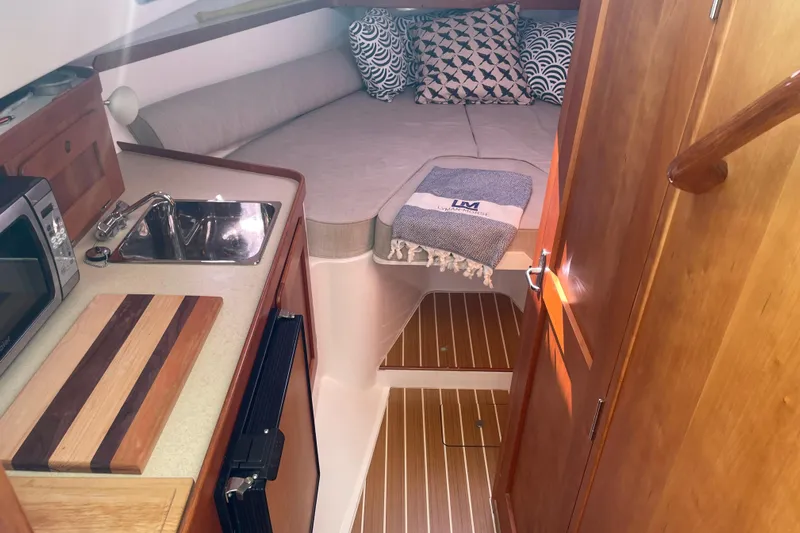 Tenacity Yacht Photos Pics Cozy cabin interior of 2012 Hunt Surfhunter with kitchenette and bed.