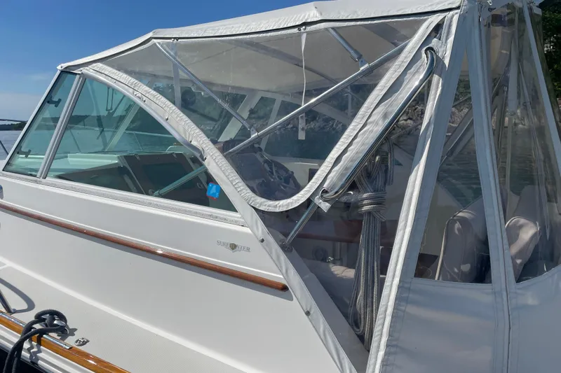 Tenacity Yacht Photos Pics 2012 Hunt Surfhunter boat with white canopy and clear windows on a sunny day.