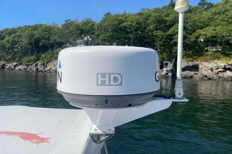 Tenacity Yacht Photos Pics Radar equipment on a 2012 Hunt Surfhunter boat, with scenic shoreline background.
