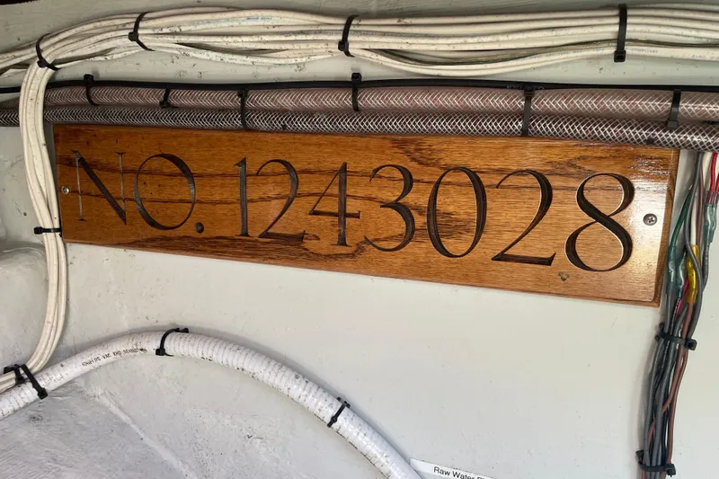Tenacity Yacht Photos Pics Wooden plaque with "No. 1243028" on a 2012 Hunt Surfhunter boat interior.