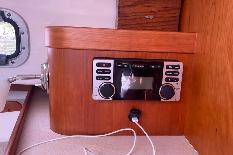 Tenacity Yacht Photos Pics Clarion stereo system on 2012 Hunt Surfhunter boat with wooden interior.