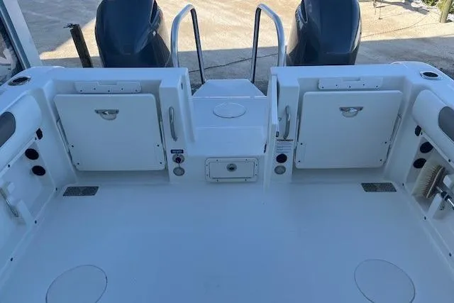  Yacht Photos Pics 2022 World Cat 255 DC boat deck with storage compartments and dual engines.