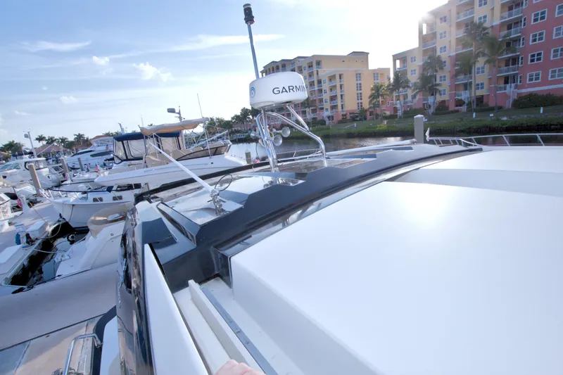 Gail Force Yacht Photos Pics 2019 Beneteau Gran Turismo 50 yacht docked at marina with modern buildings in background.