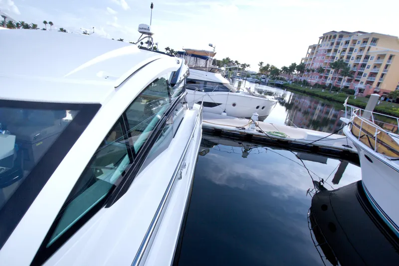 Gail Force Yacht Photos Pics 2019 Beneteau Gran Turismo 50 yacht docked in a marina, reflecting on calm water.