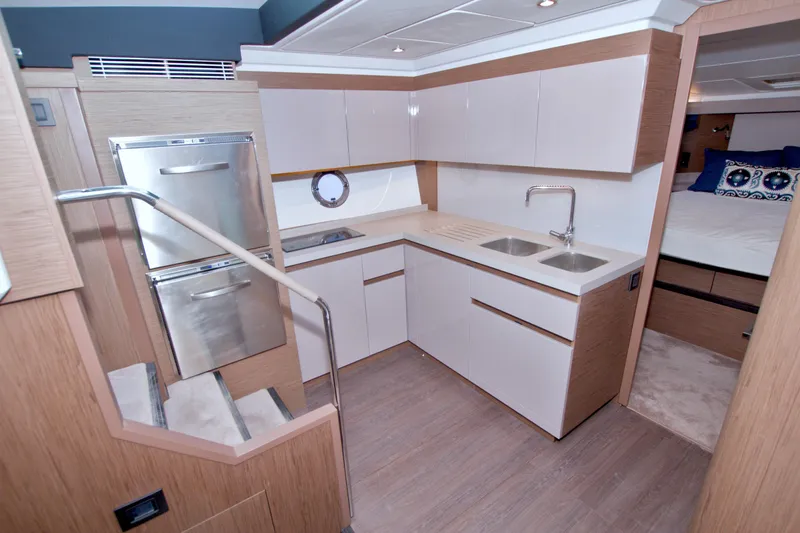 Gail Force Yacht Photos Pics Modern kitchen interior on 2019 Beneteau Gran Turismo 50 yacht, featuring sleek cabinetry and dual sinks.