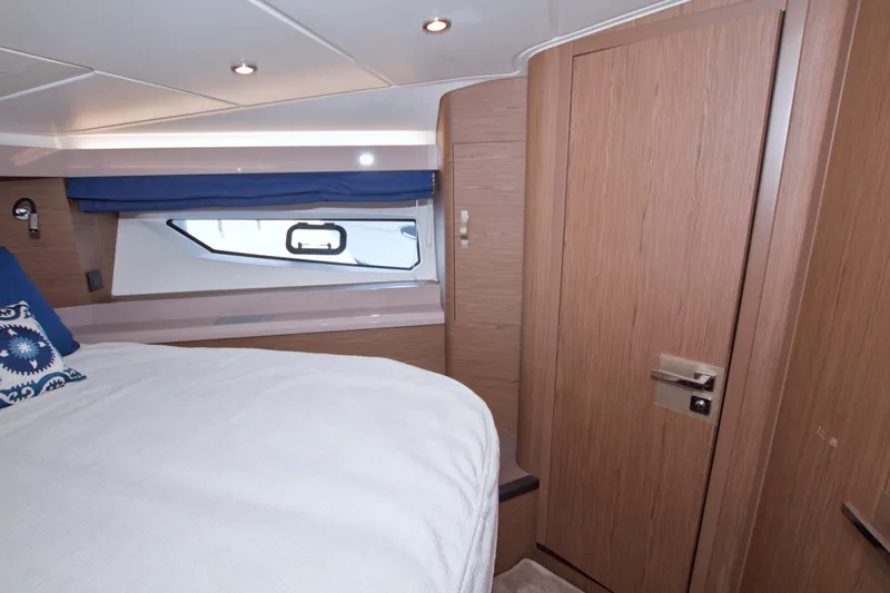Gail Force Yacht Photos Pics Luxurious cabin interior of 2019 Beneteau Gran Turismo 50 yacht with wood finish and cozy bedding.