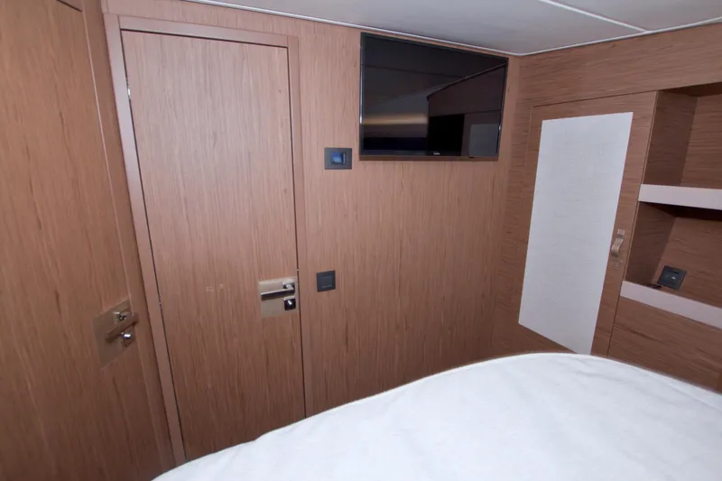 Gail Force Yacht Photos Pics 2019 Beneteau Gran Turismo 50 cabin interior with wood paneling and mounted TV.