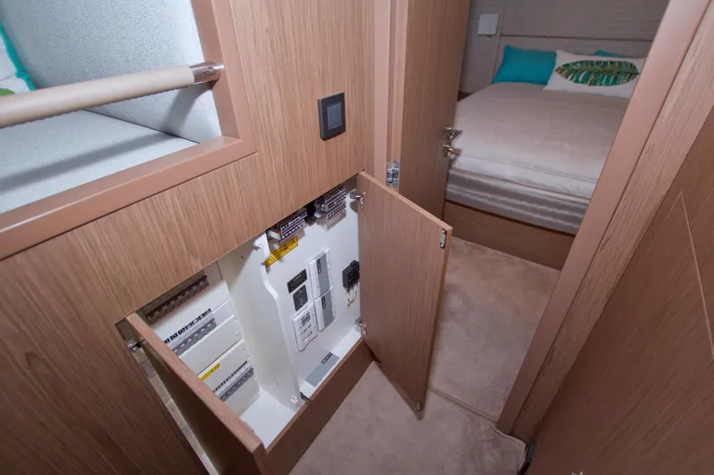 Gail Force Yacht Photos Pics 2019 Beneteau Gran Turismo 50 interior with open electrical panel and cozy bedroom.