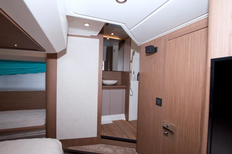 Gail Force Yacht Photos Pics 2019 Beneteau Gran Turismo 50 interior with modern wood finish and compact bathroom.
