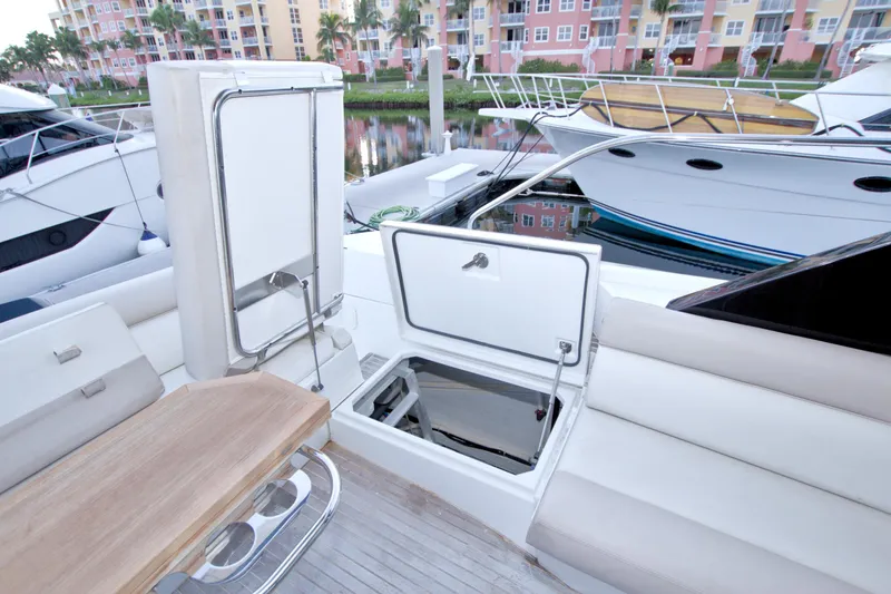 Gail Force Yacht Photos Pics 2019 Beneteau Gran Turismo 50 yacht interior with open storage compartments and seating area.